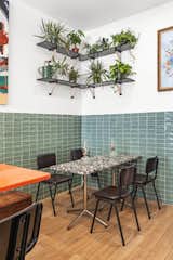 A corner table gets a tropical touch with floating shelves and plants. 