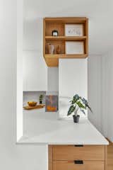 Just outside the kitchen, additional drawers and open shelving make the most of the limited square-footage.