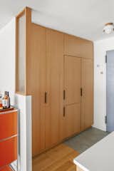 Just outside the kitchen, the entryway contains a wall of concealed storage, including an integrated refrigerator. 