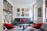 This colorful and cozy living room features a gallery wall and built-in bookcase.