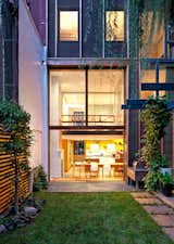 Viewed from the backyard, Greenwich Village Townhouse by Ryall Sheridan Architects gives off a warm, earthy glow.