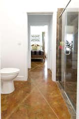 Jack and Jill Bath with step in shower room, polished concrete floors, natural light
