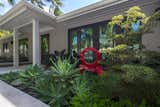 An outdoor extension of the living room.  The planting more a visual point of the living room and the sculpture is by Rob Lorenson.