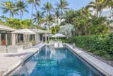 The swimming pool was resurfaced, and a shelf was added for lounging. The coping and paving around the pool was updated to White Quartzite giving it a modern, cleaner finish.