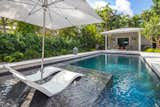 The swimming pool was resurfaced, and a shelf was added for lounging. The coping and paving around the pool was updated to White Quartzite giving it a modern, cleaner finish.