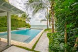 Clean, simple lines of the infinity pool allow for uninterrupted views of the Gulf and the water feature off to the side in keeping with the clean lines. Lush tropical planting was added to create textures, shade and privacy.