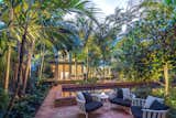 The canopy of the palms help frame the Master Suite and provide privacy from the neighbors. The different levels of the garden add interest and help define spaces within the property
