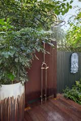 An outdoor shower was placed near the pool but tucked away to allow some privacy for those using it.