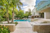 A low wall was built to create a distinct separation of space between the carport and the entrance to the house with the sense of entering into a resort.