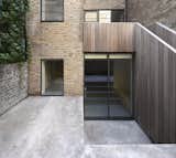 Outdoor, Side Yard, Large Patio, Porch, Deck, Concrete Patio, Porch, Deck, Vertical Fences, Wall, and Wood Fences, Wall  Photo 2 of 10 in Ladbroke Grove by Dwell from A Once-Derelict London House Restored With Modern Elegance