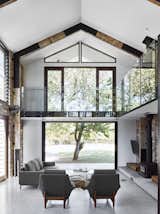 Living Room, Sofa, Chair, Wood Burning Fireplace, and Terrazzo Floor  Photos from A Brisbane Architect Designs a Light-Filled Addition For Her Brother