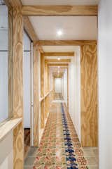 Hallway, Ceramic Tile Floor, and Medium Hardwood Floor  Photo 11 of 14 in A Dramatic Apartment Renovation in Barcelona Features Salvaged Tile and Brick