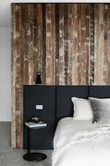 Bedroom, Bed, Wall Lighting, and Concrete Floor  Photo 7 of 9 in Recycled Wood Stars in an Ogle-Worthy Renovation in Australia