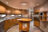 Kitchen, Dishwasher, Drop In, Cooktops, Recessed, Range, Metal, Microwave, Wood, Range Hood, and Ceiling  Kitchen Cooktops Range Hood Drop In Metal Dishwasher Photos from The Last House Designed by Frank Lloyd Wright Is Being Auctioned Without Reserve