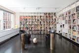 Office, Desk, Bookcase, Shelves, Study Room Type, Dark Hardwood Floor, Chair, Library Room Type, and Storage Lella Vignelli's office is lined with bookshelves. She designed the desk with legs fashioned by sculptor Arnaldo Pomodoro. The couple were known to host many cultural luminaries in the apartment, including Pomodoro and philosopher Umberto Eco.  Photo 4 of 9 in Legendary Designers Massimo and Lella Vignelli's New York Duplex Is Listed at $6.5M