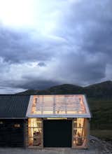 Garage, Attached Garage, Sun Room, and Storage On nice days, doors can be opened for indoor/outdoor flow.  Garage Sun Room Photos from This Astounding Cabin in Norway Is a Patchwork of Different Materials