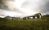 Exterior, Gable RoofLine, Cabin Building Type, Green Roof Material, Wood Siding Material, House Building Type, and Tile Roof Material Another view of the back of the building.  Photos from This Astounding Cabin in Norway Is a Patchwork of Different Materials