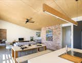 Living Room, Sofa, Recessed Lighting, Console Tables, Concrete Floor, Pendant Lighting, and Ottomans The burnished concrete floor contains ten-percent fly-ash and slag.   Photos from A New, Affordable Green Home Comes to an Australian Eco-Village