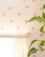 An accent wall at the head of the bed sports Hygge and West wallpaper in a rose pattern, which pays homage to the newly refreshed camper's name.