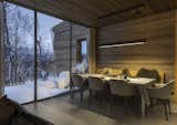 Dining Room, Pendant Lighting, Table, Chair, and Concrete Floor In the open living area, interior surfaces are clad in knot-free oak, which creates a warm contrast to the exterior.  Photo 4 of 10 in A Norwegian Family Retreat Balances Private and Communal Spaces
