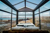 The custom-made king-sized bed is dressed with luxury duvets from Böhmerwald, Bavaria, and fluffy linen from Schlafgut, Germany. There are window blinds for the walls if more privacy is needed, while the glass roof remains exposed to the sky.