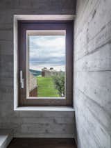 A walnut window frame captures the view outside.