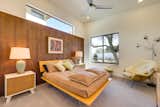 Starlight Beach Cocoa Beach model bedroom with wood panel wall and carpet floors