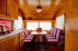 The bright, custom upholstery in this banquette mixes beautifully with the otherwise neutral color scheme.

  Photo 7 of 12 in Let Your Creativity Soar at This Eclectic Hotel With Tents, Tepees, Yurts, and Trailers