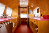This trailer features hot-pink laminate countertops, which work nicely with the surrounding woodwork.
