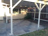 A dated brick pattern lay under the pergola.  Photo 2 of 12 in Before & After: A Neglected 1960s Ranch-Style Home Gets a Sunny Outdoor Connection