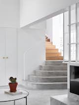 Staircase, Concrete, Metal, and Wood Concrete and timber meet again on the stairs that lead to the upper level.  Staircase Concrete Photos from A Small Australian Cottage Becomes an Airy Gathering Hub