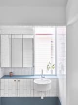 Bath, Ceramic Tile, Wall Mount, Tile, and Subway Tile At the sink area is built-in storage and a floating glass medicine cabinet.

  Bath Ceramic Tile Tile Photos from A Small Australian Cottage Becomes an Airy Gathering Hub