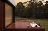 Outdoor, Hot Tub, Decking, Woodland, Small, Side Yard, and Wood A tub inset in the deck fosters a true retreat experience.  Outdoor Wood Decking Small Woodland Photos from A Secluded, Off-Grid Cabin Echoes Stunning Minimalist Design
