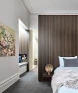 Bedroom, Bed, Night Stands, Carpet, Lamps, Bench, and Recessed Part of the renovation involved creating a master bedroom suite.  Bedroom Recessed Lamps Carpet Photos from Courtyards Maximize Sunlight in This Renovated Australian Abode