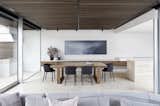 Dining, Travertine, Track, Ceiling, Table, and Chair A built-in barbecue is just accessible on the other side of the dining room. The chairs are the Pianca ‘Esse’ from Meizai.

  Dining Track Travertine Photos from Courtyards Maximize Sunlight in This Renovated Australian Abode
