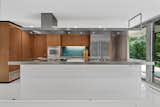 The kitchen was appropriately modernized with white lacquer and stainless steel.
