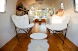 Living, Shelves, Bench, Storage, Chair, Medium Hardwood, and Rug The back area of the 250-square-foot Stolen Pony Lounge is customizable to client needs.   Living Shelves Storage Bench Rug Chair Photos from Rent This Reimagined Airstream for Your Next Shindig
