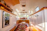 Living Room, Medium Hardwood Floor, Coffee Tables, Shelves, Bench, Storage, Ceiling Lighting, and Rug Floor Wilson transformed the interior of this 1974 airstream so it could be used for a variety of purposes, such as a dressing room for Iggy Pop and Beck during the Project Pabst Music Festival in Portland, Oregon.

  Photos from Rent This Reimagined Airstream for Your Next Shindig