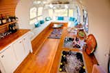 Living, Bench, Medium Hardwood, Coffee Tables, Rug, Shelves, and Storage The interior includes a blue tooth/CD/iPod-receiver sound system, AC, and mini fridge.

  Living Rug Shelves Coffee Tables Bench Photos from Rent This Reimagined Airstream for Your Next Shindig