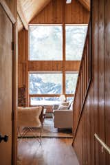 A big draw when Jenny and Allie bought the cabin were the huge windows in the main living area. The flooring was all replaced, but the knotty pine paneling was left in place in order to maintain the home's authentic Vermont charm. 