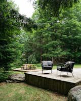 Outdoor, Large Patio, Porch, Deck, Decking Patio, Porch, Deck, Trees, and Back Yard The wrap-around deck is a fantastic summer destination, outfitted in finds from Amazon and Target.  Search “fantastic plastics” from Budget Breakdown: A Creative Couple Rehab a Vermont Cabin for $18K