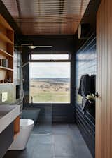 Bath, Ceramic Tile, Vessel, Full, Wall, Ceramic Tile, Corner, and Open The view is the focal point in a bathroom sheathed in charcoal tile and complemented by wood accents.

  Bath Vessel Ceramic Tile Ceramic Tile Open Photos from Simplicity Reigns at This Off-Grid Australian Retreat