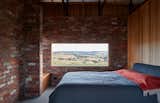 Bedroom, Bench, Bed, Concrete Floor, and Storage "The house provides the means to eat, sleep, and wash in a space that is part of the experience of being on the site and not removed from it," add the architects.

  Photos from Simplicity Reigns at This Off-Grid Australian Retreat
