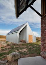 The shed was custom-designed with a shed kit company, and is clad in heritage-grade corrugated galvanized iron. It houses land-care equipment, as well as the PV panels and battery. 