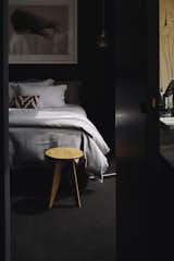 Bedroom, Bed, Carpet, Night Stands, and Pendant A cozy bedroom.  Bedroom Carpet Night Stands Pendant Photos from A Striking Black House Appears to Float in the New Zealand Mountains