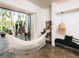 Bedroom, Ceiling, Bed, Bench, Concrete, Pendant, and Night Stands Some rooms come with hammocks, and there's even a "Hammock Tower" for rooftop lounging.  Bedroom Concrete Pendant Bench Photos from Become a Hotelier in a Surfer's Paradise With This Chic Boutique Property Asking $2.6M