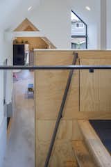 A custom steel railing on the ladder leads to the loft.