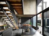 Kitchen, Range Hood, Slate, Dishwasher, Metal, Range, Refrigerator, Colorful, and Undermount Double-height glass now lets the communal living areas spill out onto an exterior courtyard.  Kitchen Slate Undermount Colorful Photos from A Sleek Addition Lets a Melbourne Home and Garden Freely Merge