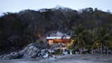 Exterior, Beach House Building Type, Flat RoofLine, Wood Siding Material, Stone Siding Material, and House Building Type  Photo 1 of 7 in In Mexico, a Modern Palapa and Pool Are Carved Into a Rocky Slope