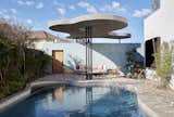 The architects brought the undulating lines outside with the pool's shape and overhead awning. 
